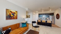 Located at 7325 Liberty Summit Dr in Powell, Ohio, this single-floor residence offers a thoughtfully designed open-concept layout that seamlessly connects the living, dining, and kitchen areas. The living room is bright and welcoming, highlighted by a large window and glass patio door that invite abundant natural light and provide outdoor views. Plush carpeting anchors the space, which flows naturally into a dedicated dining area.

The kitchen is a standout feature, showcasing rich dark cabinetry, granite-look countertops, and a full suite of stainless steel appliances including a refrigerator, electric range, and built-in microwave. A peninsula with seating for two and stylish pendant lighting adds both function and visual appeal. Wood-style flooring in the kitchen adds a warm contrast to the cabinetry.

The primary bedroom is generously sized with carpeted floors, direct access to a walk-in closet, and an en-suite bathroom featuring a glass-enclosed shower, dark vanity cabinetry, granite countertops, and wood-style flooring. A second full bathroom offers a tub-shower combination with similarly refined finishes. An additional flexible room serves well as a home office or den, complete with a window for natural light. The overall palette of neutral tones throughout creates a calm, cohesive ambiance.