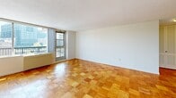 Located on the 8th floor at 146 St Marys St in Boston's vibrant Fenway neighborhood, this one-bedroom, one-bathroom unit offers a well-designed layout across a single floor. The living room is a standout space, featuring classic parquet wood flooring in a warm honey tone and large floor-to-ceiling windows with access to a balcony, filling the room with natural light and offering open city views. The same distinctive parquet flooring continues throughout the unit, providing a cohesive look and feel. The kitchen is thoughtfully appointed with white cabinetry, light countertops, and an eye-catching green and beige mosaic tile backsplash. It includes a full suite of white appliances — refrigerator, electric range, built-in microwave, and dishwasher — alongside light tile flooring. The spacious primary bedroom features a large closet with louvered doors and a window with city views, making it a comfortable and functional retreat. The bathroom is finished with classic white subway tile in the tub/shower surround, accented by a dark tile border, mosaic tile flooring, and stainless steel grab bars. A dedicated closet provides additional storage, completing this practical and well-appointed urban residence.