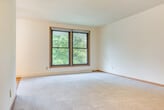 Located at 6309 Lakeview Blvd in Middleton, WI, this single-floor, three-bedroom, one-bathroom home offers a practical and comfortable layout. The living areas feature a combination of plush carpeting and warm hardwood flooring, creating a welcoming atmosphere throughout. Two distinct living room areas provide flexible space for lounging or dining.

The kitchen is equipped with oak cabinetry, generous counter space, and a full-size refrigerator, with tile flooring that transitions seamlessly into the carpeted living areas. Each of the three bedrooms features hardwood floors, ceiling fans, and sliding double-door closets offering abundant storage. Several bedrooms include windows that let in natural light and provide views of the surrounding greenery.

A central hallway connects the bedrooms to the shared full bathroom, which includes a vanity with a large countertop sink, wood cabinetry, and a medicine cabinet mirror. With six closets throughout, storage is plentiful. The home also includes an entrance area and a private patio, ideal for outdoor relaxation. The neutral color palette and classic wood accents give this home a clean, timeless character.