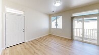 Located at 1024 Prospect Ave in Santa Rosa, CA, this 2-bedroom, 1-bathroom single-story home offers a practical and comfortable layout with thoughtful design details throughout. Light wood laminate flooring runs through the main living areas, lending a clean, bright aesthetic that complements the neutral wall tones found throughout the space.

The combined kitchen and dining area is well-appointed with warm honey-toned wood cabinetry offering generous storage, white appliances including a refrigerator, electric range, microwave, and dishwasher, along with a stainless steel sink. The adjacent living room benefits from multiple windows and a sliding glass door that opens to a private outdoor balcony, filling the space with natural light and greenery views.

Both bedrooms are carpeted and bathed in natural light from well-placed windows. The primary bedroom features a spacious double-door closet and direct proximity to the bathroom. The second bedroom also includes ample closet space. The shared bathroom is equipped with a tub and shower combination with sliding glass doors.

Additional features include a utility room, hallway connecting the main areas, and three closets for added storage throughout. The overall ambiance is clean, functional, and move-in ready.