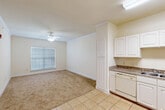 This single-story, one-bedroom, one-bathroom residence at 2056 Antoine Drive in Houston, Texas offers a practical and comfortable layout across a compact, efficient floor plan. The heart of the home is an open-concept space combining the living room, dining area, and kitchen, creating a seamless and functional flow. The living area features warm beige carpeting, crown molding, and a ceiling fan with light fixture, with a window fitted with blinds that allows natural light to fill the room.

The kitchen is well-appointed with white cabinetry offering ample storage, granite-look countertops, a double-basin sink, a dishwasher, an electric range, and a full-size refrigerator. Light ceramic tile flooring runs throughout the kitchen and extends into adjoining utility areas.

The bedroom is a generously sized retreat with plush carpet, crown molding, a ceiling fan, and a window with blinds. The full bathroom includes a tub/shower combination with white tile surround, multiple grab bars for accessibility, a wall-mounted medicine cabinet, and tile flooring. A dedicated laundry room with washer and dryer hookups and overhead shelving adds convenience. The unit is completed by a hallway, closet, and utility room, rounding out a well-organized and functional living space.