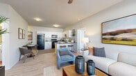 This well-appointed 2-bedroom, 2-bathroom residence in Lakeville, MN offers a thoughtfully designed single-floor layout that maximizes functionality and comfort. The open-concept living and kitchen area forms the heart of the home, featuring light wood-style flooring, neutral tones, and a ceiling fan that enhances the airy feel. The kitchen is equipped with white cabinetry, dark countertops, full black appliance suite including a refrigerator, range, microwave, and dishwasher, and a peninsula with bar seating — ideal for casual dining. The living room receives natural light through large windows with blinds and provides a welcoming, comfortable atmosphere. Both bedrooms are carpeted and feature generous windows that allow ample natural light, with the primary bedroom offering a notably spacious footprint. The two full bathrooms are finished with wood-style vinyl flooring, white vanities, large mirrors, and full tub-shower combinations. A dedicated closet provides additional storage. The clean, modern aesthetic and practical layout make this residence a functional and inviting home in the Lakeville community.