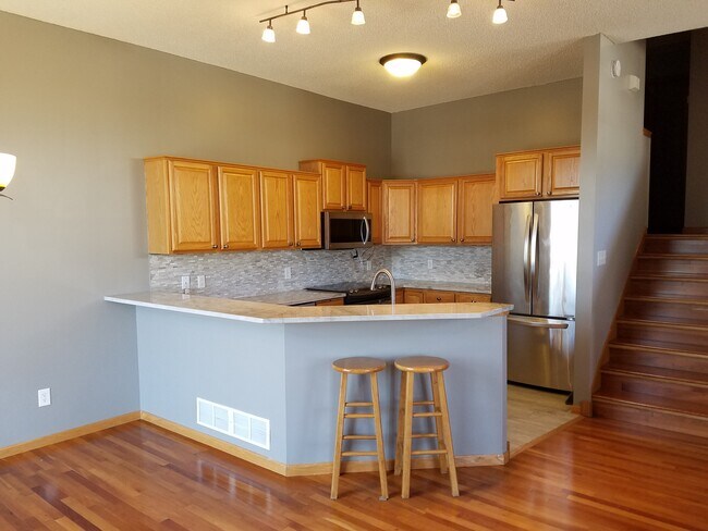 Kitchen with french-door stainless steel fridge, microwave, dishwasher and brand new electric stove. With under cabinet lighting - 20068 Heritage Dr