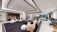 Located at 1991 Main Street in downtown Sarasota, Florida, this sophisticated amenity floor spans nearly 3,000 square feet of thoughtfully designed communal space. The interior is defined by a refined contemporary aesthetic, featuring coffered ceilings with recessed lighting and dark accent trim, pristine white walls, and a striking deep-navy patterned carpet that anchors the open floor plan.

The expansive main lounge serves as the centerpiece, offering multiple distinct seating clusters furnished with curved white upholstered chairs, plush sofas, and warm wood accent tables. A rich, textured feature wall with gold-framed artwork adds a dramatic focal point. The space flows seamlessly into a secondary lounge area, where high-back tufted chairs and additional soft seating arrangements create intimate conversation nooks.

The game room is a standout feature, housing a full-size billiards table beneath elegant pendant lighting, a circular card table surrounded by tufted swivel chairs, a wall-mounted TV, and built-in shelving. Adjacent to the game area is a dedicated indoor golf simulator room, complete with a high-definition projection screen, synthetic turf hitting mat, and comfortable spectator seating. Natural light filters in through large windows, enhancing the polished, upscale ambiance throughout the entire floor.