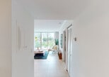 Located at 1550 Brickell Ave in Miami, FL, this thoughtfully designed single-floor residence offers a clean, contemporary aesthetic throughout. A welcoming entryway with large louvered doors leads into a bright, open-plan living area bathed in natural light from expansive floor-to-ceiling sliding glass windows and doors. The living space features light tile flooring, bold colorful artwork, and a multi-arm floor lamp that adds a modern, artistic flair. Lush palm tree views from the windows reinforce the tropical Miami setting.

The dining area is defined by a striking glass-top round table surrounded by vibrant red chairs, positioned adjacent to a pass-through window that connects directly to the kitchen, enhancing the open feel. The kitchen is efficiently laid out with white cabinetry, dark granite countertops, stainless steel appliances including a full-size refrigerator, and light tile flooring that complements the rest of the home.

The bedroom is a serene retreat, finished in soft neutral tones with plush carpeting, sheer curtains diffusing gentle natural light, and a tufted white upholstered headboard as a centerpiece. The bathroom features a full tub-shower combination with clean white tile, dark granite vanity countertops, and a warm, spa-like atmosphere. Overall, this residence combines modern design with a light, airy Miami ambiance.