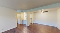 Located at 647 West Barstow Avenue in Clovis, CA, this single-floor, 2-bedroom, 2-bathroom home offers a functional and well-organized layout. The living room is a welcoming space featuring wood-style flooring, a ceiling fan with light fixture, and a front entry door, creating a bright and airy atmosphere. A textured ceiling carries throughout the common areas, adding a classic residential character.

The kitchen is efficiently designed with white cabinetry, a laminate countertop, a double-basin sink, a dishwasher, and a range, all complemented by a peninsula counter that opens toward the dining area — ideal for casual meals or additional prep space.

Both bedrooms are comfortably sized and carpeted, each equipped with a ceiling fan and vertical blind-covered windows that allow natural light and outdoor views. The primary bedroom features mirrored sliding closet doors, adding a sense of depth to the room. A second closet provides additional storage elsewhere in the home.

The two bathrooms are clean and straightforward in design, featuring neutral tones and practical fixtures including towel bars. A dedicated utility room and hallway round out the layout, contributing to the home's overall efficient use of space. Wood-style flooring flows consistently through the main living areas, tying the home together cohesively.