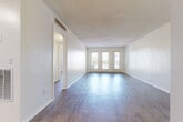 Located at 100 Seabreeze Blvd in Daytona Beach, Florida, this one-bedroom, one-bathroom residence offers a well-organized, efficiently designed layout ideal for coastal living. The open living room is a standout feature, showcasing wood-style flooring, textured walls, and a set of French doors flanked by sidelights that flood the space with natural light and provide access to a private balcony — offering a glimpse of the surrounding Daytona Beach environment. The kitchen is thoughtfully appointed with crisp white shaker cabinetry, granite-style countertops, a stainless steel range with overhead exhaust, and light tile flooring, creating a clean and functional cooking space. The bedroom is a comfortable retreat featuring light wood-style flooring, a window with outdoor views, built-in open shelving, and a dedicated closet with bifold doors and a full-length rod for ample storage. The bathroom is finished with white subway tile surrounding the tub-shower combination, tile flooring, and a clean, classic aesthetic. A hallway connects the rooms seamlessly, completing this well-planned single-floor residence in a prime beachside location.