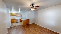 Located at 7806 SW Blue Jay Ln in Bentonville, Arkansas, this single-floor, one-bedroom, one-bathroom home offers a practical and well-organized layout. Warm hardwood-style flooring runs throughout the main living areas and bedroom, providing a cohesive and inviting aesthetic. The living room welcomes you upon entry, featuring a ceiling fan with light fixture, neutral-toned walls, and a front door with a decorative arched transom window that brings in natural light. A standard window with blinds adds to the brightness of the space. The bedroom continues the same hardwood-style flooring and is equipped with its own ceiling fan and a window overlooking the exterior, keeping the room well-ventilated and naturally lit. The kitchen is efficiently designed, offering ample warm-toned wooden cabinetry, generous counter space, a double-basin sink, a stainless steel dishwasher, a refrigerator, and a range — all set on easy-to-maintain tile flooring. A dedicated utility room and a closet provide additional storage and functional support. The bathroom features tile flooring consistent with the kitchen. Throughout the home, the clean, neutral color palette and functional design elements create a comfortable and practical living environment suited for everyday life.