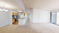 This single-floor, 3-bedroom, 2-bathroom home in Jacksonville, FL (32218) offers a well-organized layout designed for comfortable everyday living. The entryway leads into an open living area featuring plush carpeting, a textured ceiling, and a sliding glass door that opens onto a private balcony with views of mature trees — an ideal spot for relaxing outdoors. Adjacent to the living room, the dining area is accented by a stylish chandelier and flows directly into the galley-style kitchen. The kitchen is equipped with warm wood cabinetry, stainless steel appliances including a refrigerator, electric range, and built-in microwave, complemented by laminate countertops and hardwood-style flooring. The three bedrooms are carpeted and filled with natural light from large windows fitted with horizontal blinds. The generously sized primary bedroom includes a walk-in closet outfitted with dual wire shelving systems for ample storage. Both bathrooms feature wood-toned vanity cabinetry with white countertops; one includes a shower/tub combination. A dedicated laundry room with washer/dryer hookups and overhead shelving adds everyday convenience. Throughout the home, neutral tones and practical finishes create a clean, move-in-ready atmosphere.