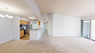 This single-floor, 3-bedroom, 2-bathroom home in Jacksonville, FL (32218) offers a well-organized layout designed for comfortable everyday living. The entryway leads into an open living area featuring plush carpeting, a textured ceiling, and a sliding glass door that opens onto a private balcony with views of mature trees — an ideal spot for relaxing outdoors. Adjacent to the living room, the dining area is accented by a stylish chandelier and flows directly into the galley-style kitchen. The kitchen is equipped with warm wood cabinetry, stainless steel appliances including a refrigerator, electric range, and built-in microwave, complemented by laminate countertops and hardwood-style flooring. The three bedrooms are carpeted and filled with natural light from large windows fitted with horizontal blinds. The generously sized primary bedroom includes a walk-in closet outfitted with dual wire shelving systems for ample storage. Both bathrooms feature wood-toned vanity cabinetry with white countertops; one includes a shower/tub combination. A dedicated laundry room with washer/dryer hookups and overhead shelving adds everyday convenience. Throughout the home, neutral tones and practical finishes create a clean, move-in-ready atmosphere.