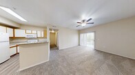 Located at 3703 Wurzbach Rd in San Antonio, TX, this single-floor, one-bedroom, two-bathroom residence offers a functional and well-organized layout. The combined kitchen and living area forms the heart of the home, with the kitchen showcasing white cabinetry accented by warm wood trim, granite-style countertops, a full suite of white appliances, and durable wood-look flooring. A peninsula counter provides a natural transition into the carpeted living room, which features a ceiling fan and a sliding glass door that fills the space with natural light and opens to an outdoor area. The bedroom is generously proportioned, featuring plush carpet, a ceiling fan, a window with outdoor views, and direct access to a spacious walk-in closet outfitted with wire shelving on multiple walls for ample storage. Both bathrooms are clean and practical, with one featuring a full tub-shower combination, wood-look flooring, and granite-style countertops. A connecting hallway links the main living spaces efficiently. Throughout the unit, neutral warm-beige walls and consistent finishes create a cohesive, move-in-ready atmosphere suited for comfortable everyday living.