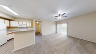 Located at 3703 Wurzbach Rd in San Antonio, TX, this single-floor, one-bedroom, two-bathroom residence offers a functional and well-organized layout. The combined kitchen and living area forms the heart of the home, with the kitchen showcasing white cabinetry accented by warm wood trim, granite-style countertops, a full suite of white appliances, and durable wood-look flooring. A peninsula counter provides a natural transition into the carpeted living room, which features a ceiling fan and a sliding glass door that fills the space with natural light and opens to an outdoor area. The bedroom is generously proportioned, featuring plush carpet, a ceiling fan, a window with outdoor views, and direct access to a spacious walk-in closet outfitted with wire shelving on multiple walls for ample storage. Both bathrooms are clean and practical, with one featuring a full tub-shower combination, wood-look flooring, and granite-style countertops. A connecting hallway links the main living spaces efficiently. Throughout the unit, neutral warm-beige walls and consistent finishes create a cohesive, move-in-ready atmosphere suited for comfortable everyday living.