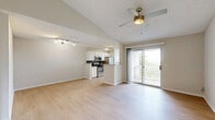 Located at 570 Church St E in Nashville, TN, this one-bedroom, one-bathroom unit offers a well-designed layout across a single floor. The open-concept living and dining area is immediately welcoming, featuring light hardwood-style flooring, vaulted ceilings, and a ceiling fan that enhances airflow and comfort. Sliding glass doors lead to a private balcony overlooking lush greenery, filling the space with natural light. The kitchen is outfitted with white cabinetry, granite countertops, a gray subway tile backsplash, and stainless steel appliances including a refrigerator, range, and over-the-range microwave. The living area also includes a front entry closet for additional storage. The spacious bedroom is carpeted and features a ceiling fan, a large window with natural light, and direct access to a well-sized walk-in closet with built-in shelving and hanging rods. The bathroom is finished with a wide granite-topped vanity, white cabinetry, a large mirror, and a stylish multi-bulb light fixture, complemented by hardwood-style flooring. Neutral tones and textured ceilings throughout the unit create a clean, cohesive aesthetic.