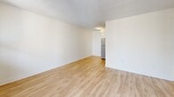 Located at 43 Forest Ave in Hamilton, Ontario, this one-bedroom, one-bathroom unit spans two floors, offering a well-organized and functional layout. Light-toned hardwood flooring runs throughout, complementing the clean white walls and textured ceilings to create a bright, airy atmosphere.

The main floor houses the primary living areas, including a spacious living room with large sliding glass doors that open onto a private balcony with views of the surrounding neighbourhood. An additional windowed room provides versatile space bathed in natural light. The galley-style kitchen is thoughtfully designed, featuring white cabinetry, dark countertops, a white subway tile backsplash, and stainless steel appliances including a full-sized refrigerator, stove, and over-the-range microwave. A clean entryway with light hardwood flooring provides a welcoming transition into the unit.

The full bathroom is finished with white subway tile surrounding a soaker tub and shower combination, a white vanity, and large-format floor tiles. The bedroom includes a built-in sliding door closet and connects to additional storage space. The second floor offers supplementary living area, completing this efficiently designed multi-level home.