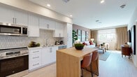 Located at 25440 Solaris Pl in Murrieta, CA, this thoughtfully designed 2-bedroom, 1-bathroom home offers a cohesive blend of modern aesthetics and functional living across a single floor. The open-concept kitchen and living area serves as the heart of the home, featuring a sleek kitchen outfitted with white flat-panel cabinetry, matte black hardware, a geometric tile backsplash, stainless steel appliances including a French door refrigerator, range, microwave, and dishwasher, and a butcher block island with bar seating. Light wood-style flooring flows throughout, enhancing the bright, airy atmosphere. The living room is a warm, inviting space accented by a terracotta feature wall, large windows that draw in natural light and outdoor views, and soft carpeting underfoot. Both bedrooms offer a cozy retreat, with the primary bedroom highlighted by a bold red accent wall and garden views through a generously sized window. The full bathroom features a clean white vanity, tub-shower combination, and warm accent walls. A hallway with wood flooring connects the private areas of the home, which also includes a dedicated closet for added storage.