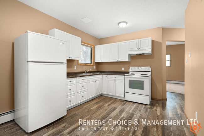 Building Photo - MAIN FLOOR UNIT With Assigned Parking