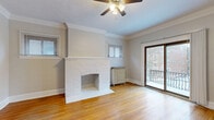 Located at 2773 Hampshire Rd in Cleveland Heights, Ohio, this one-bedroom, one-bathroom unit blends classic architectural character with functional updates throughout its well-organized single-floor layout. Warm hardwood floors extend seamlessly through every room, tying the space together with a cohesive, timeless aesthetic.

The living room serves as the focal point of the home, anchored by a painted white brick fireplace with a classic arched opening. Crown molding lines the ceiling, adding a refined architectural detail, while a ceiling fan, multiple windows, and a sliding glass door opening to a private balcony fill the room with natural light and provide outdoor views.

The kitchen features white shaker-style cabinetry, granite-look countertops, stainless steel appliances including a dishwasher and refrigerator, and a window overlooking the exterior. A cast-iron radiator adds to the unit's period charm. Crown molding continues into this space as well.

The spacious bedroom offers generous proportions, hardwood floors, and ample natural light from a large window. Four closets distributed throughout the unit provide exceptional storage.

The bathroom is finished with classic white tile surrounding a full soaking tub and shower, complemented by a frosted privacy window. The overall ambiance is clean, bright, and character-rich, reflecting the enduring appeal of Cleveland Heights architecture.
