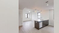 Located at 201 Cornelison Avenue in Jersey City, NJ, this thoughtfully designed one-bedroom, one-bathroom residence offers a efficient and modern living experience across a single floor. Light wood-tone flooring flows consistently throughout, lending a clean, cohesive aesthetic to the entire unit.

The open-concept kitchen and living area serves as the heart of the home. The kitchen features a large island with a crisp white countertop, an undermount sink, dark wood cabinetry, subway tile backsplash, and a full suite of stainless steel appliances including a refrigerator, range, and microwave. Stylish pendant lighting hangs above the island, while multiple windows fill the combined space with natural light and views of the surrounding neighborhood.

The bedroom is a bright, serene retreat with large dark-framed windows that allow generous natural light. The space is finished with the same light wood flooring and clean white walls.

The bathroom is neatly appointed with large-format tile flooring, a tub-shower combination with white tile surround, a modern vanity with storage, and a medicine cabinet mirror. In-unit laundry and three closets provide excellent storage and convenience. The overall design is clean, contemporary, and functional throughout.