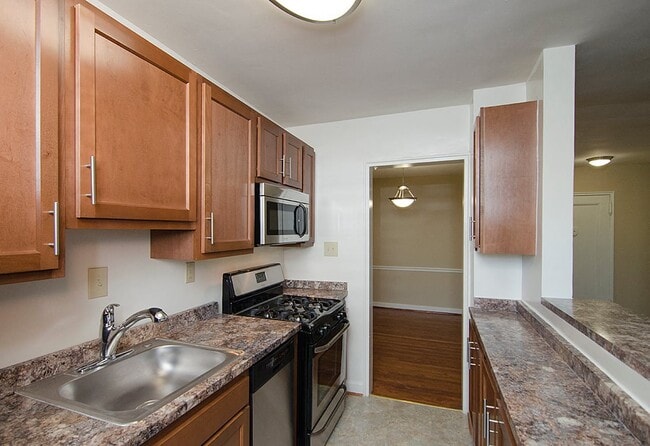 Partially renovated kitchen with stainless steel appliances - Mason Hall