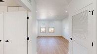 Unit 405 at 2580 El Camino Real in Redwood City, CA offers a thoughtfully designed one-bedroom, one-bathroom residence with a clean, contemporary aesthetic. Light-toned hardwood flooring runs throughout the entire unit, creating a warm and cohesive look. Recessed lighting illuminates every room, complementing the crisp white walls and bright, airy atmosphere.

The open-concept kitchen and living area serves as the heart of the unit. The kitchen is outfitted with sleek white cabinetry extending to the ceiling for ample storage, a white tile backsplash, and a full suite of stainless steel appliances including a refrigerator, electric range, built-in microwave, and dishwasher.

The spacious bedroom features dual windows with city views, recessed lighting, and two closets, offering generous storage. The bathroom is finished in an all-white palette with a full tub/shower combo and wood-look tile flooring that mirrors the rest of the unit.

Additional highlights include a private balcony, an in-unit laundry area, a dedicated utility room, and black-accented hardware details throughout that add a modern touch. The unit's well-considered layout makes efficient use of its space, providing comfortable, move-in-ready living in the heart of Redwood City.