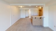 Located at 7191 Turtle Creek Ct in Perrysburg, Ohio, this single-floor unit offers a clean, functional layout with a neutral color palette throughout. The living area is bright and inviting, featuring plush carpeting and a pair of large windows alongside a glass patio door that fills the space with natural light and provides direct access to the outdoors, offering pleasant views of the surrounding greenery.

The kitchen is designed for practicality, featuring an L-shaped layout with ample cream-toned cabinetry — both upper and lower — accented with warm wood-toned trim and hardware. Generous counter space and a gas range make this kitchen well-suited for everyday cooking. A wood-paneled breakfast bar connects the kitchen to the main living and dining area, enhancing the open feel of the space.

The bedrooms are carpeted and finished with clean white walls, providing a calm and comfortable atmosphere. Louvered closet doors offer organized storage solutions within the sleeping quarters. The bathroom is finished with tile flooring in a warm earth tone, a single-basin vanity with a large mirror, and a full shower and tub combination. Chrome fixtures and towel bars complete the utilitarian design. Overall, the unit presents a straightforward, well-organized living environment in a residential Perrysburg neighborhood.