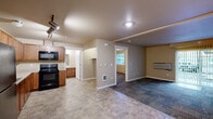 Located at 13660 W Sixth Ave in Airway Heights, WA, this one-bedroom, one-bathroom unit offers a practical and comfortable single-floor layout. The open-concept living and dining area features durable tile-style flooring and a wall-mounted HVAC unit, providing efficient climate control. Track lighting in the main living space adds a modern touch while ensuring the area is well-lit throughout.

The kitchen is efficiently designed in an L-shaped configuration, featuring warm wood cabinetry with ample upper and lower storage, light-colored countertops, a double-basin sink, a black electric range with overhead microwave, and a dishwasher. Tile flooring runs throughout the kitchen, complementing the cabinetry tones.

The bedroom offers a cozy, carpeted retreat with a large sliding double-panel closet, providing generous storage space. A window allows for natural light and ventilation, while a baseboard heater ensures warmth during cooler months.

The bathroom is clean and functional, complete with a full tub-shower combo, a wood-vanity with sink, and tile flooring that ties the space together. Neutral warm tones throughout the unit create a cohesive and inviting atmosphere. A dedicated closet area near the kitchen provides additional storage or laundry hookup potential.