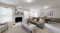 Located at 2001 W Princeton Cir in Broken Arrow, Oklahoma, this single-story residence offers a thoughtfully designed layout with a warm, welcoming ambiance throughout. The living room serves as the heart of the home, centered around a classic white-mantled fireplace flanked by windows that invite natural light. Plush carpeting and neutral tones create a comfortable, cohesive atmosphere ideal for relaxing or entertaining.

The kitchen is well-appointed with rich wood cabinetry, a granite-style countertop, tile flooring, and a peninsula breakfast bar with seating — perfect for casual dining. A dining area adjacent to the living space features a large window, providing a bright setting for meals and easily accommodating a full dining set.

The bedrooms are generously proportioned, each finished with soft carpeting and ceiling fans for year-round comfort. Windows offer natural light, and ample closet space ensures practical storage. The full bathroom is cleanly finished with warm wood cabinetry, a tiled tub-shower combination, a wide vanity with a single basin, and tile flooring.

Throughout the home, consistent neutral color palettes, carpeted living areas, and tile in wet spaces contribute to a cohesive and functional design suited for comfortable everyday living.