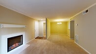 Located at 629 Arbor Station Ln in Tallahassee, FL, this single-story, 3-bedroom, 2-bathroom home offers a well-organized and comfortable layout. The combined living and dining area serves as the heart of the home, featuring warm neutral-toned walls, plush carpeting, crown molding, and a classic fireplace with a white mantel. A chandelier illuminates the dining space, while French doors flood the living area with natural light and open directly to a private patio with outdoor views. The kitchen is equipped with white cabinetry, subway tile backsplash, light stone countertops, a double sink, and wood-look flooring, with a pass-through view into the dining area. Each of the three bedrooms offers carpeted floors and closet space, with the primary bedroom featuring a notably generous walk-in closet with wire shelving. Bedrooms are fitted with ceiling fans for added comfort. The bathrooms include a full tub-shower combination with clean white surrounds. Additional highlights include a dedicated laundry area, utility room, hallway connecting all rooms, and six total closets providing exceptional storage throughout. A welcoming entrance completes this functional and well-appointed home.