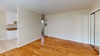 This 470 square foot apartment in Sacramento, CA offers a well-designed living space on a single floor. The layout includes a spacious 140 square foot bedroom, a full bathroom, and an open-concept kitchen and living area. The kitchen is equipped with white appliances, including a gas range and full-size refrigerator, complemented by ample white cabinetry and granite countertops. The living spaces showcase a mix of flooring types, with warm hardwood in the main living area and plush carpeting in the bedroom. The bathroom features a tub-shower combination with sliding glass doors and a single vanity. Throughout the apartment, ceiling fans and large windows provide good air circulation and natural light. The neutral color palette and clean lines create a modern, airy feel. This compact yet functional space is ideal for single occupancy or a couple, offering a comfortable living environment in an urban setting.