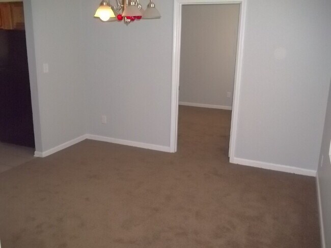 Building Photo - Freshly painted and new flooring in this 4 Bedroom 2 and Half Bath home. Covered front porch with...