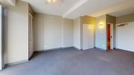 This 740 square foot apartment in Des Moines offers a thoughtful layout with two bedrooms and two bathrooms. The primary bedroom is notably spacious at 430 square feet, providing ample living space. The bathrooms are designed with accessibility in mind, featuring tiled walls, grab bars, and a step-in bathtub with a shower.

The living areas are characterized by a neutral color palette, with warm beige walls and grey carpeting in the bedrooms. The common areas showcase durable tile flooring, creating a practical and easy-to-maintain space. The apartment benefits from natural light, with windows visible in several rooms.

Climate control is ensured with a wall-mounted air conditioning unit, providing comfort year-round. Built-in closets offer storage solutions, while the open floor plan allows for flexible furniture arrangement. The overall design prioritizes functionality and comfort, making it an ideal choice for those seeking a low-maintenance urban living experience in Des Moines.