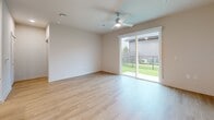 Located at 11305 Grant Rd in Houston, TX, this single-story, 2-bedroom, 2-bathroom home offers a thoughtfully designed layout with modern finishes throughout. Light wood flooring flows seamlessly across the entire space, creating a bright and cohesive aesthetic.

The kitchen serves as a standout feature, showcasing crisp white shaker cabinetry, a subway tile backsplash, granite countertops, and a full suite of stainless steel appliances including a gas range, microwave, dishwasher, and side-by-side refrigerator. A central island with an undermount sink adds both functionality and style.

The living area is generously proportioned, bathed in natural light from large sliding glass doors that open to an outdoor patio and green lawn — ideal for indoor-outdoor living. Ceiling fans are present throughout.

Both bedrooms are well-sized, each featuring large windows with blinds that invite natural light, and ceiling fans for year-round comfort. Two closets provide ample storage, including a walk-in closet with wire shelving systems.

The two bathrooms are finished with granite-topped white vanities and wood-look flooring. One bathroom features a tiled tub-shower combo, while the other includes a glass-enclosed walk-in shower, offering versatility for residents.