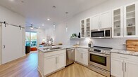 Located at 3500 Cox Rd in Henrico, VA, this well-appointed one-bedroom, one-bathroom residence offers a thoughtfully designed open-concept layout finished with contemporary details throughout. Light hardwood flooring flows seamlessly across the entire living space, complementing the bright, neutral palette of the walls and ceilings.

The kitchen is a standout feature, showcasing white shaker-style cabinetry, a striking granite-topped peninsula with bar seating and a built-in sink, and a full suite of stainless steel appliances including a French door refrigerator, gas range, built-in microwave, and dishwasher. A subway tile backsplash, glass-front upper cabinets, a built-in wine rack, and elegant pendant lighting complete the polished look.

The living room is bright and inviting, with recessed lighting, crown molding, and a ceiling fan. A sliding glass door opens to a private balcony, bringing in abundant natural light and outdoor views. The bedroom offers a comfortable, well-proportioned retreat with a window for natural light and direct access to the closet. The bathroom features a tiled tub-shower combination enclosed by a glass panel door with chrome fixtures, paired with wood-look flooring for a clean, modern finish.