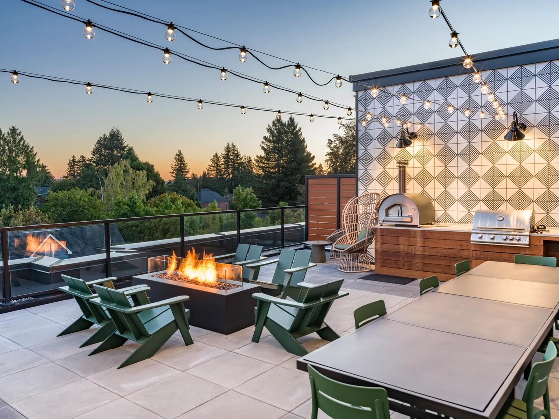 Ascend to the 5th floor retreat featuring a TV lounge, fireplace, full kitchen, and an outdoor terrace equipped with a grilling station and pizza oven. - Modera Woodstock