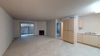 This single-story residence at 52 Pheasant Ct in Pittsburg, California offers a straightforward, functional layout designed for comfortable everyday living. The main living area is generously proportioned, featuring a combination of tile flooring and carpet, and is anchored by a fireplace that serves as a central focal point. Vertical blinds frame a sliding glass door that opens to a private patio, allowing natural light to filter into the space and providing a seamless connection to the outdoors.

The kitchen is efficiently designed in an L-shaped configuration, equipped with light wood cabinetry offering ample storage, white appliances including an electric range, built-in microwave, dishwasher, and refrigerator, as well as light-toned countertops. Tile flooring extends throughout this area, transitioning to carpet in the adjoining spaces. The front entry area sits adjacent to the kitchen, providing a practical and accessible entrance.

The bedroom features carpeted flooring and a window with blinds that brings in natural light and outdoor views. The bathroom includes a tub and shower combination enclosed by sliding glass doors, a single-sink vanity with light wood cabinetry, and a well-lit mirror. Additional practical features include an electrical panel and interior storage areas accessible via hallway doors.