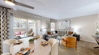 This single-level residence in San Ramon, California, delivers a practical and well-organized floor plan encompassing a living room, bedroom, kitchen, and full bathroom. Neutral-toned walls and carpeted flooring run throughout the main living areas, creating a warm and cohesive ambiance.

The living room serves as the central gathering space, featuring two windows that invite natural light and a sliding glass door that opens directly to a private outdoor patio—ideal for indoor-outdoor living. A dedicated dining area sits adjacent, making the space functional for both everyday use and entertaining.

The galley-style kitchen is efficiently arranged with dark cabinetry lining both sides, light countertops, hardwood-style flooring, and a full suite of appliances including a refrigerator, electric range, microwave, and dishwasher.

The bedroom accommodates a queen or larger bed comfortably, featuring carpet flooring, a window with blinds for natural light, and a sliding-door closet with built-in shelving and hanging rods for organized storage.

The full bathroom includes a tub-shower combination, a single vanity with a granite-style countertop, dark cabinetry, and hardwood-style flooring, completing the unit's consistent design aesthetic.