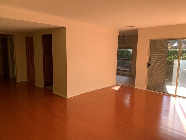 View as you enter the unit. Living room/dining room. Sliding door leads to private patio. - 3366 Woodburn Rd