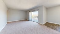 Located at 1900 54th Ave S in Saint Petersburg, Florida, this 2-bedroom, 2-bathroom residence offers a thoughtfully organized single-floor layout. The entrance leads into a spacious living room finished with neutral-toned carpet and light gray walls, anchored by large sliding glass doors that open onto a private balcony with views of the surrounding greenery — filling the space with generous natural light. The kitchen is a standout feature, showcasing stainless steel appliances including a refrigerator and electric range, granite countertops, crisp white cabinetry, and light wood-look flooring — creating a clean, contemporary aesthetic. Both bedrooms are comfortably sized, carpeted, and feature vertical blinds over windows that bring in ample daylight. The spacious primary bedroom provides a comfortable retreat with well-proportioned dimensions. The two bathrooms are finished in clean white, one featuring a tiled tub/shower combination and the other a walk-in shower with chrome fixtures. Textured ceilings are consistent throughout, and the neutral color palette lends a calm, cohesive ambiance to the entire residence. This well-appointed home offers practical, comfortable living in a convenient Saint Petersburg location.