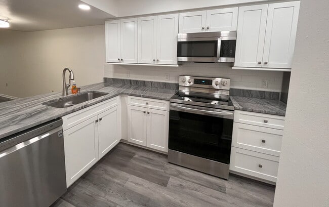 Building Photo - Two-story condominium, featuring 2 bedrooms and 2 1/2 bathrooms