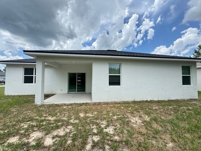 Foto del edificio - Modern 4-Bedroom Home in Poinciana – Get 5...