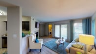 This single-story residence offers a thoughtfully designed layout that balances open communal spaces with private retreats. The living room serves as the heart of the home, featuring light wood-style flooring, a fireplace, and large sliding glass doors that invite ample natural light and provide outdoor views. A dedicated in-unit laundry area is conveniently accessible from the living space.

The kitchen is outfitted with dark espresso cabinetry, granite countertops, stainless steel appliances including a refrigerator, dishwasher, and range with microwave above, and a double sink. A breakfast bar connects the kitchen to the main living area, creating a seamless flow.

The dining area is a defined yet open space with elevated ceilings and room for a full dining set. Both bedrooms are generously sized, featuring plush carpeting, ceiling fans, and large windows. One bedroom includes a walk-in closet. The two bathrooms feature granite-topped vanities, framed mirrors, and a tub-shower combination. Neutral tones throughout the residence create a cohesive and welcoming ambiance.