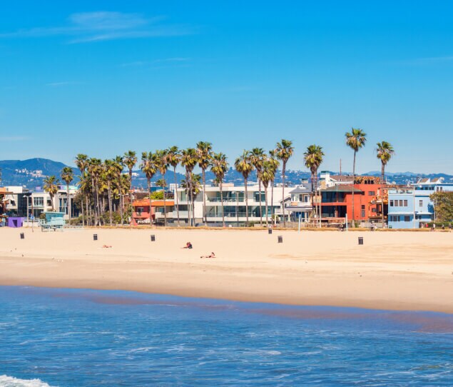 Beachfront houses with mountains in the background