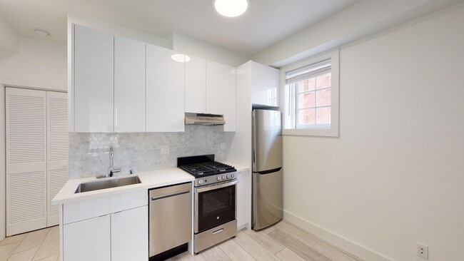 Kitchen with cabinets, refrigerator, stove, range hood, and sink - 2500 Durant Avenue