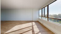 This well-designed apartment offers 910 square feet of living space on a single floor, featuring two bedrooms and two bathrooms. The primary bedroom is generously sized at 170 square feet, providing ample space for comfort and relaxation. Throughout the apartment, light wood-toned flooring creates a warm and inviting atmosphere, complemented by crisp white walls that enhance the sense of space and brightness.

Large windows in the living areas and bedrooms allow natural light to flood the interior, creating a airy and open feel. The apartment boasts a modern, minimalist aesthetic with clean lines and a neutral color palette. Both bathrooms feature contemporary fixtures, including white vanities and toilets, with one bathroom showcasing large, neutral-toned floor tiles.

The layout is thoughtfully designed for functionality, with a hallway connecting the various rooms. Baseboard heating units are visible in some rooms, ensuring comfort throughout the year. The apartment's design emphasizes simplicity and efficiency, making it an ideal space for those seeking a contemporary urban living experience in London, Ontario.