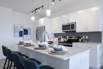 Open Kitchen with Stainless Steel Appliances - Deco Apartments