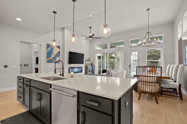 Kitchen opens into living and dining area, with pool and backyard through rear door. - 1003 Cardinal Ln