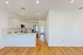 Located at 3089 James Ct in Lake Charles, Louisiana, this well-appointed single-story home offers a thoughtfully designed layout across two bedrooms and two bathrooms. Warm hardwood flooring flows consistently throughout, lending a cohesive and inviting feel to every room.

The kitchen is a standout feature, showcasing white shaker-style cabinetry with matte black hardware, a classic subway tile backsplash, light quartz countertops, and a full suite of stainless steel appliances including a gas range, over-the-range microwave, and a large French door refrigerator. A peninsula provides additional prep and dining space.

The living and dining areas offer an open, airy atmosphere complemented by recessed lighting. The bedrooms are bright and comfortable, each with windows that invite natural light and ceiling fans for added comfort. The primary bedroom is generously sized with ample room for a full furniture arrangement.

Both bathrooms are finished in crisp white with matte black fixtures, and the home includes a dedicated laundry room with washer and dryer hookups and overhead cabinetry. Well-lit hallways connect the spaces seamlessly. Outside, the home sits in a tidy residential neighborhood with a lawn and fenced backyard, offering a welcoming suburban setting.