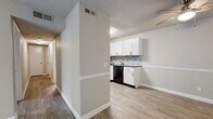 Located at 700 Airways Circle in Nashville, TN, this single-story, one-bedroom, one-bathroom unit offers a thoughtfully designed layout across a compact yet functional floor plan. The open-concept living and dining area is finished with wood-look luxury vinyl plank flooring and a ceiling fan, creating a bright and airy atmosphere. A sliding glass door leads to a private balcony overlooking lush greenery, filling the space with natural light. The kitchen is well-equipped with white shaker cabinetry, dark granite-style countertops, a mosaic tile backsplash, and a full suite of black appliances including a refrigerator, range, microwave, and dishwasher. The bedroom features plush carpeting, a ceiling fan, and a window that brings in natural light. A dedicated closet provides ample storage, while a separate laundry area with an in-unit washer and dryer adds everyday convenience. The bathroom includes a full tub and shower combination. Hallways connect the rooms efficiently, and the textured ceilings throughout lend a consistent finish to the space. Neutral tones and clean finishes give the unit a move-in-ready appeal.