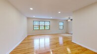 Located at 824 Mountain Ave in Westfield, NJ, this well-maintained one-bedroom, one-bathroom space offers a thoughtfully organized single-floor layout. The living room is a standout feature, showcasing gleaming hardwood floors that run throughout, recessed lighting, a ceiling fan, and multiple windows that flood the room with natural light and offer pleasant outdoor views — creating a bright, open atmosphere. The generously sized bedroom continues the hardwood flooring and includes a dedicated closet, a ceiling fan, and a window that brings in additional natural light. The kitchen is equipped with warm oak cabinetry, dark granite countertops, a tile backsplash, and a full suite of stainless steel appliances including a range, microwave, and refrigerator, all set atop clean white tile flooring. The bathroom is finished with neutral, linear wall tiling surrounding a soaking tub, complemented by a white vanity with classic hardware and a window for ventilation. A hallway connects the rooms efficiently, contributing to the space's functional flow. Clean lines, neutral tones, and consistent hardwood flooring throughout give the space a cohesive and inviting character.