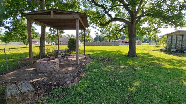 fenced in back yard with fire pit and covered sitting area, pecan tree - 708 Vincent St